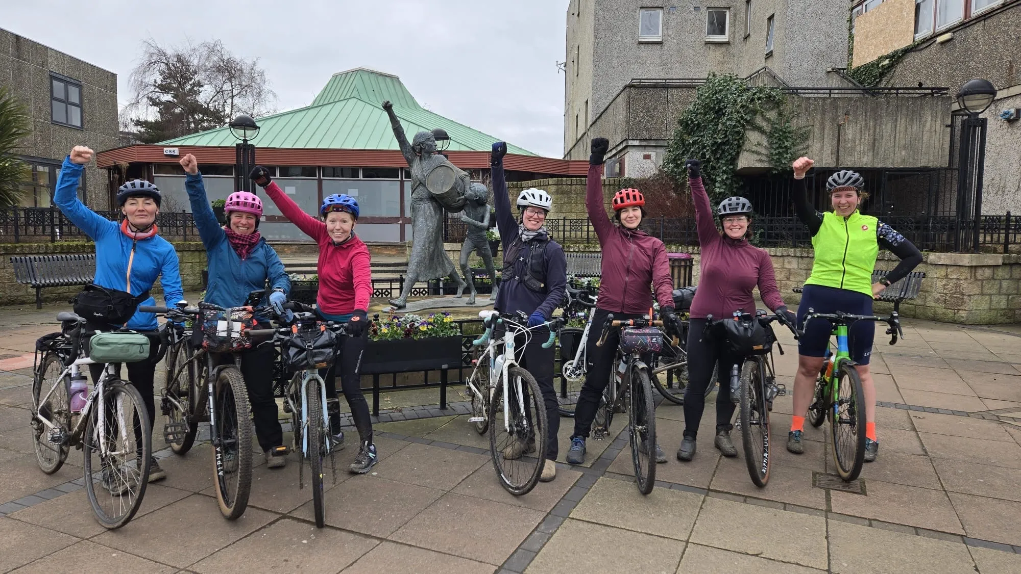 Picture of Queens of Pain members with raised fists.